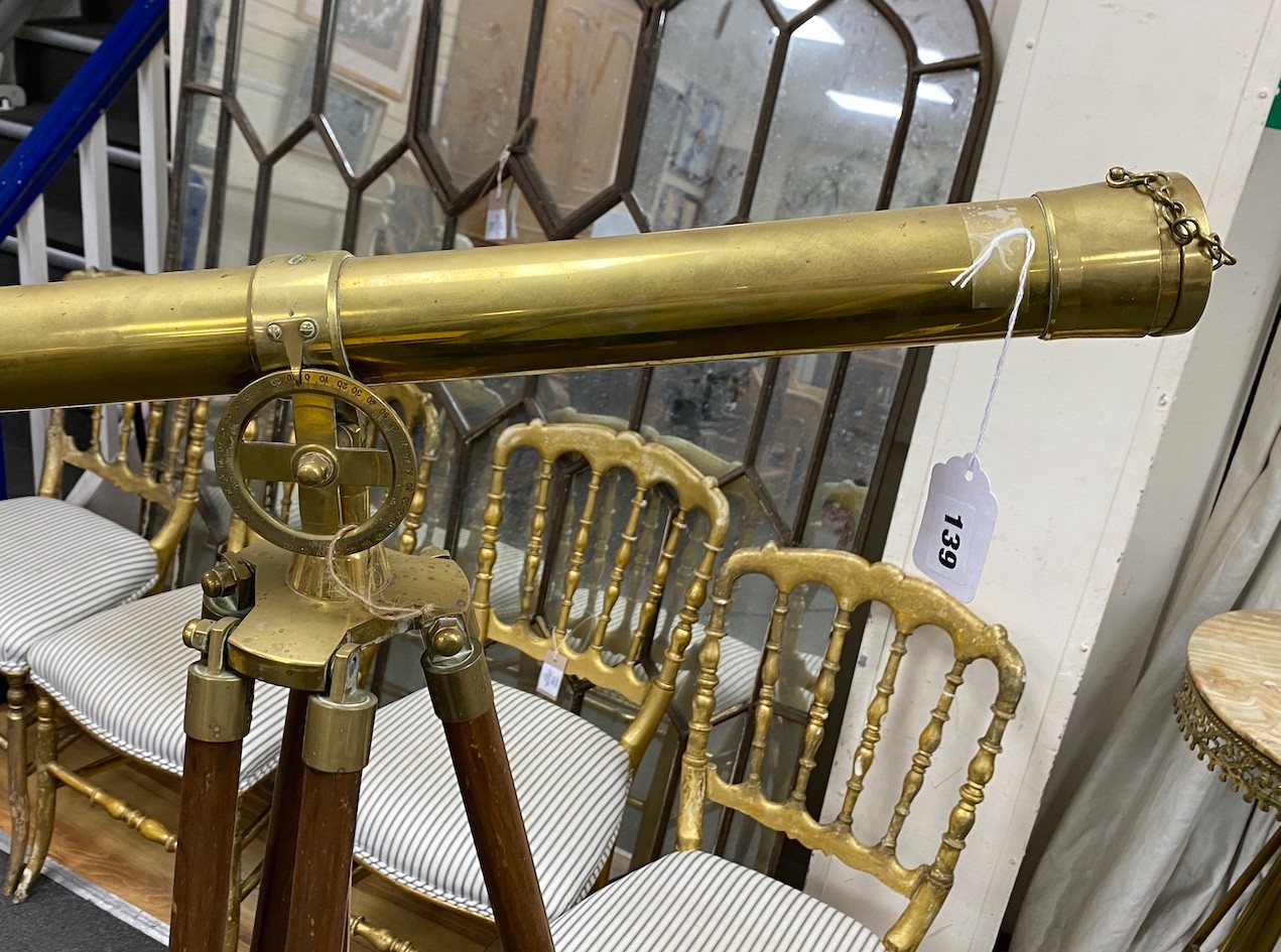 A Victorian style brass telescope on folding tripod, telescope length 71cm